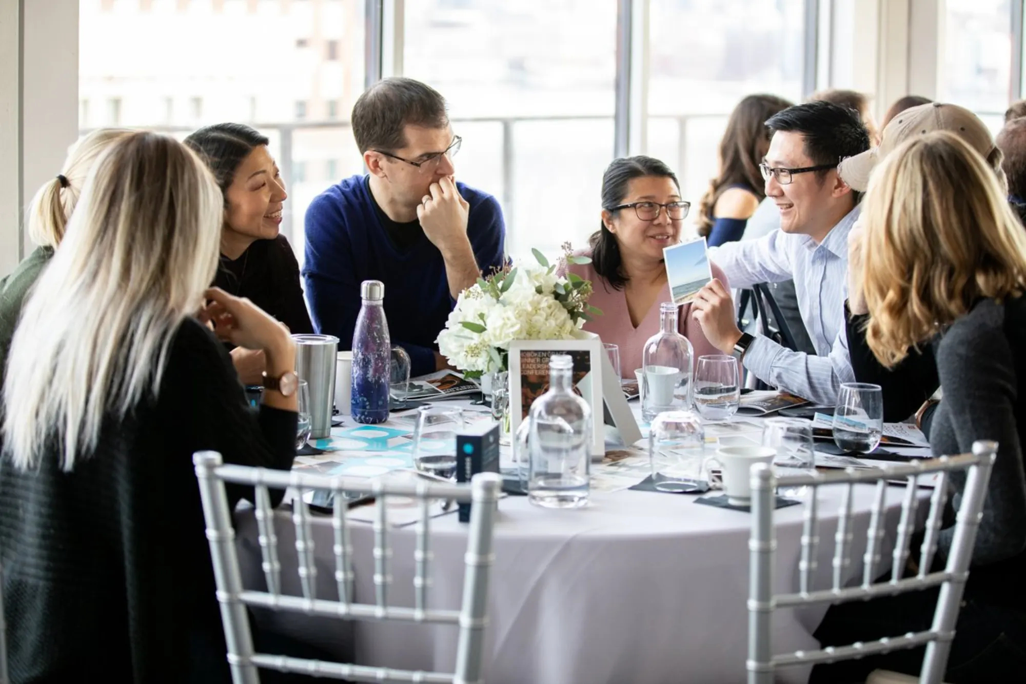 A Dinner Group sharing a meal around a long table