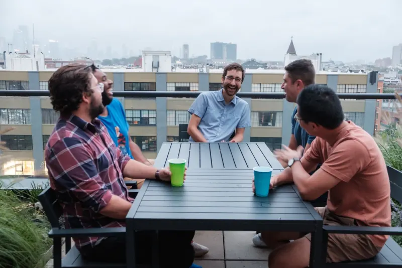 A Dinner Group talking on a rooftop