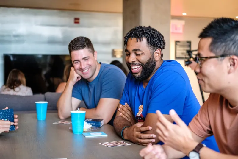 Two men laughing together at a Dinner Group