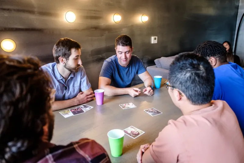 Men playing a card game around a table