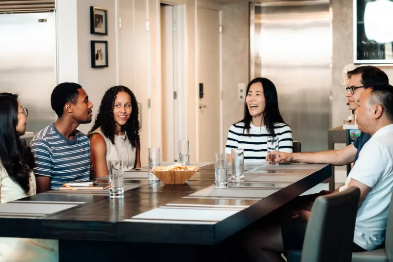 A Dinner Group talking around a dinner table