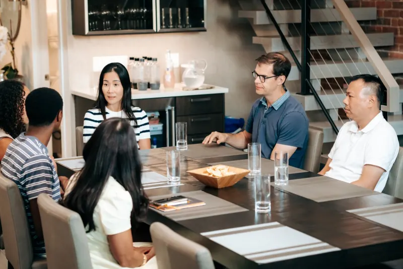 A Dinner Group talking around a dining table