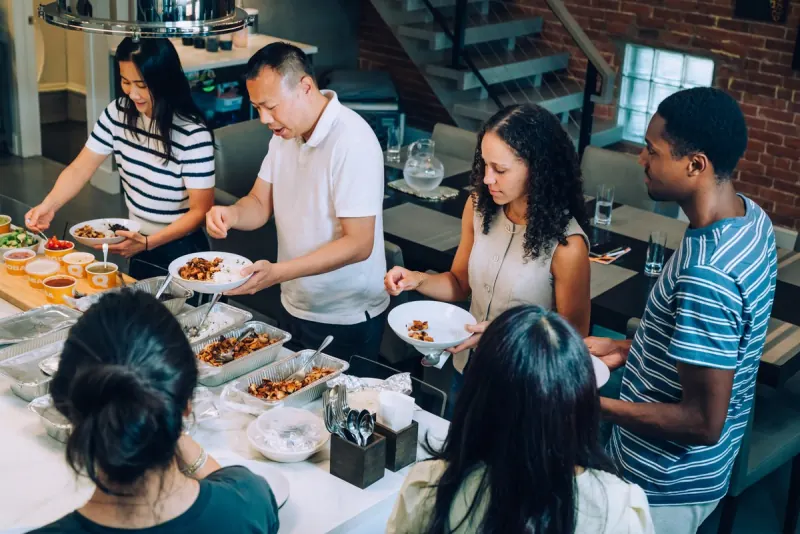A Dinner Group serving dinner together