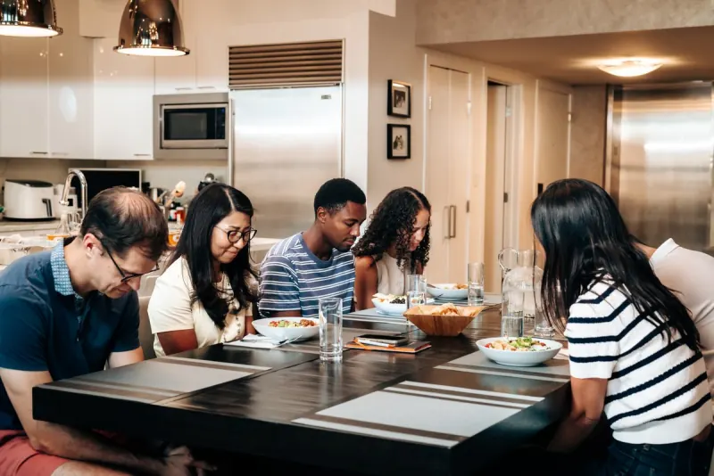 A Dinner Group sharing a meal around a table