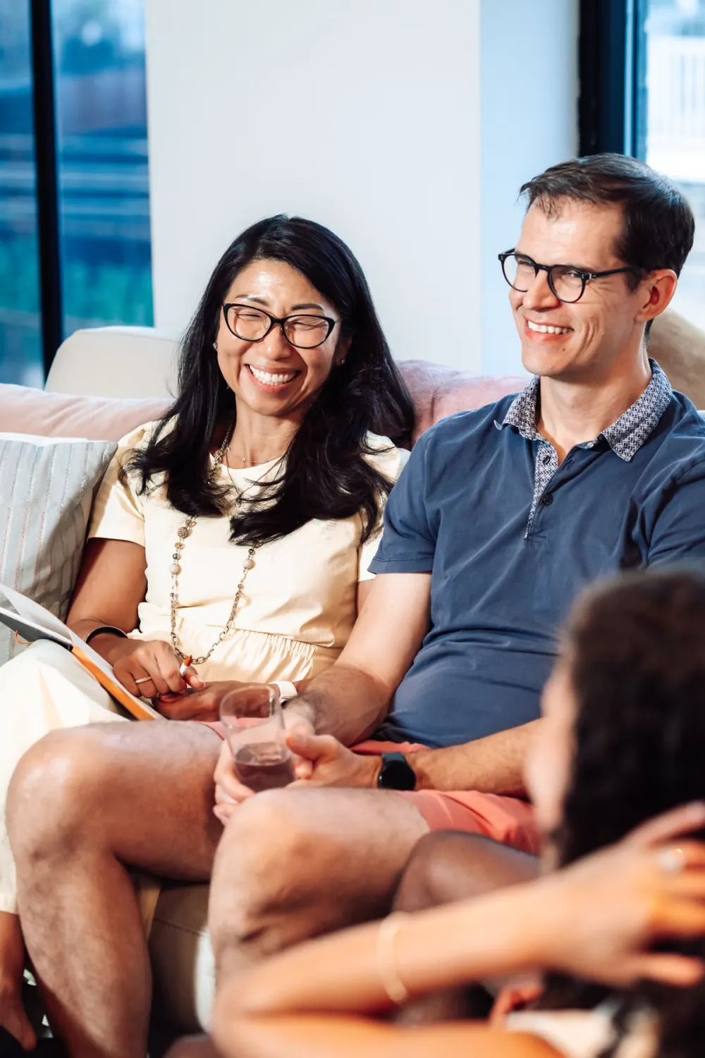 A couple laughing together on a couch