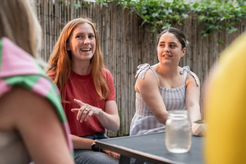 Two women in conversation at a Dinner Group