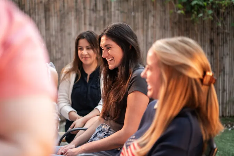 Women laughing together at a Dinner Group