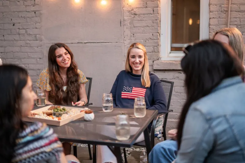 Two women talking at an outdoor table