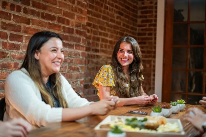 Two women talking across a table
